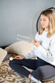 A woman meditating on the floor with Meinl Crystal Tuning Fork 261.63 HZ / C4, 15".