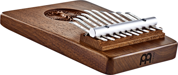 A Meinl wooden box with a set of 10 notes Kalimba, Tree Of Life, Black Walnut on it, perfect for musicians interested in sound healing therapy.