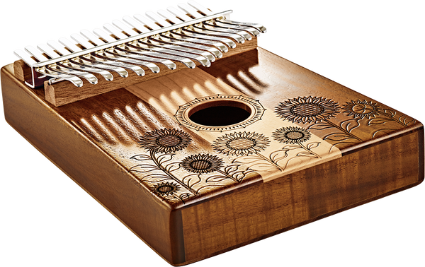 The Meinl 17 notes Kalimba, Maple & Acacia is a wooden melodic instrument adorned with beautiful sunflowers, producing enchanting musical tones in the C Major scale.