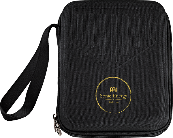 A black case with a gold logo on it, holding the Meinl Sonic Energy Sound Hole Kalimba - a 17 notes Kalimba, Maple & Acacia melodic instrument with a C Major scale.