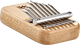 A Meinl 8 notes Kalimba, Maple wood box with a set of pliers on it.
