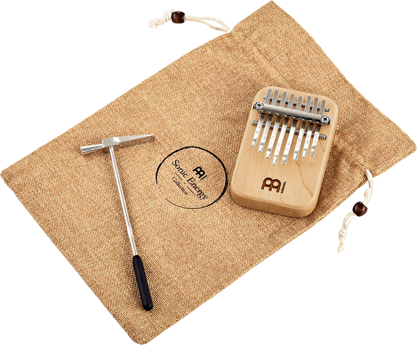 A melodic instrument, a Meinl 8 notes Kalimba made of maple wood, in a bag.
