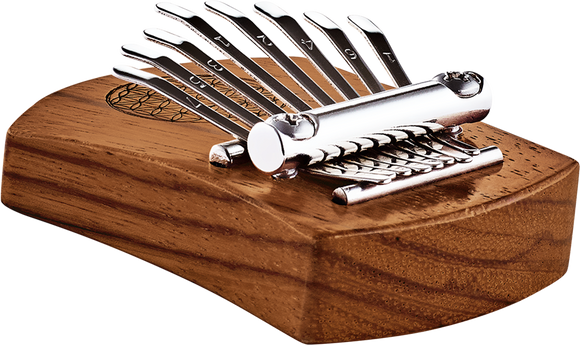A Meinl 8 notes Kalimba, Flower Of Life, Red Zebrawood, also known as a thumb piano, resting on top of a wooden box, creating soothing sounds for sound healing therapy.