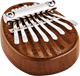 A Meinl Sapele wood ukulele with a set of metal tines.