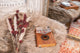 A Meinl Mahogany Kalimba with 17 notes sits on top of a fur rug.