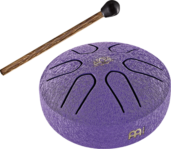 A Meinl 3" Tongue Drum, A Major, Lotus Flower, Purple with a wooden stick.