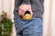 A man, who is a sound therapist, is holding a yellow coin in his pocket while playing the Meinl 3" Tongue Drum, A Major, OM, Gold.